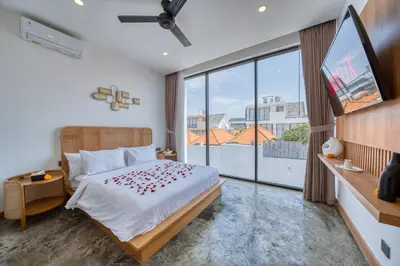 a bedroom with a bed and a large window at Modern 3bd Tropical Villa with Pool in Central Umalas in Canggu