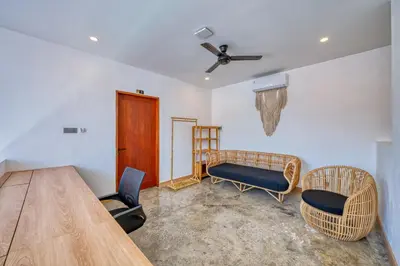 a living room with a table and two chairs at Modern 3bd Tropical Villa with Pool in Central Umalas in Canggu