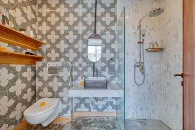 a bathroom with a sink and a toilet and a shower at Modern 3bd Tropical Villa with Pool in Central Umalas in Canggu