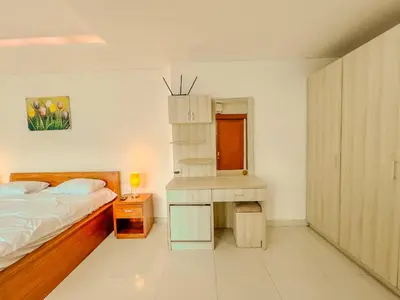 a bedroom with a bed and a desk and a bed sidx sidx sidx at Jasmine Villa in Nusa Dua