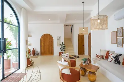 a living room with a couch and chairs at Ocean View 4BR Design Villa with Lap Pool & Rooftop Jacuzzi in Jimbaran