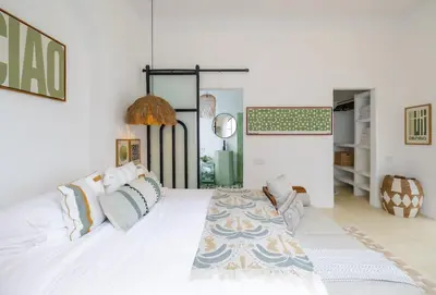 a bedroom with a large white bed with pillows at Ocean View 4BR Design Villa with Lap Pool & Rooftop Jacuzzi in Jimbaran