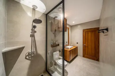 a bathroom with a shower and a toilet and a sink at Tuluscoliving Villa Legian 4 Bedrooms and 4 Bathroom in Legian