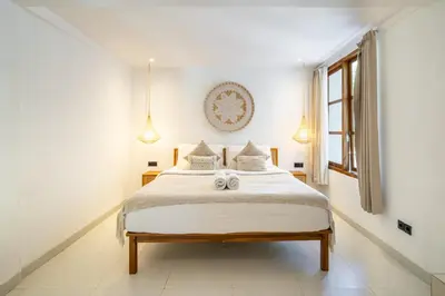 a bedroom with a bed with two stuffed animals on it at Tuluscoliving Villa Legian 4 Bedrooms and 4 Bathroom in Legian