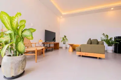 a living room filled with lots of plants and a couch at Anatari 3 BR Private Pool Villa in Seminyak