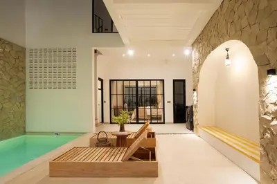 a pool in the middle of a room with a house at Leva Villa - Luxury 3BR Jimbaran in Jimbaran
