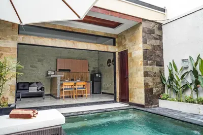 a backyard with a swimming pool and a kitchen at Villa Maharani Sanur in Sanur