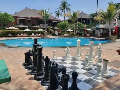 a chess board in front of a swimming pool at Apartemen 6236 at Jayakarta Residence Bali in Seminyak