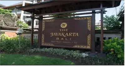 a sign in front of a building in a yard at Apartemen 6236 at Jayakarta Residence Bali in Seminyak