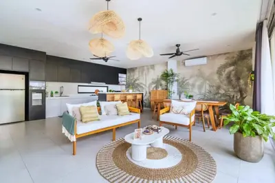 a living room with a couch and a table at Bimala 3 BR Private Pool Villa in Seminyak