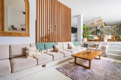 a living room with a white couch and a table at Bimala 3 BR Private Pool Villa in Seminyak