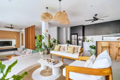 a living room with a couch and a table at Bimala 3 BR Private Pool Villa in Seminyak