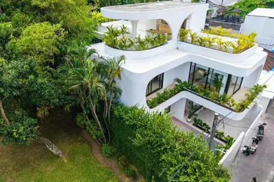 an aerial view of a white house with plants at Tropical Chic Villa w Rooftop & Pool in Seminyak in Seminyak