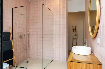 a bathroom with a glass shower and a sink at Tropical Chic Villa w Rooftop & Pool in Seminyak in Seminyak