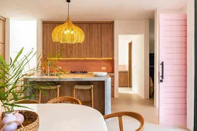 a kitchen with a table and a pendant light at Tropical Chic Villa w Rooftop & Pool in Seminyak in Seminyak