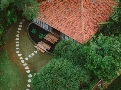 an overhead view of a building with a bench and trees at Magia de Uma, a Member of Design Hotels in Canggu