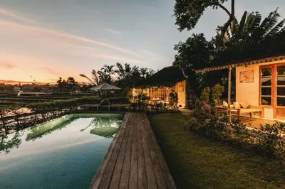a house with a pool in front of a building at Magia de Uma, a Member of Design Hotels in Canggu