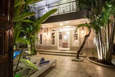 a lobby with palm trees in a building at D Villa Seminyak in Seminyak