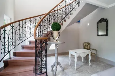 a staircase with a table and a plant on it at D Villa Seminyak in Seminyak
