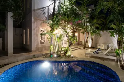 a pool in the middle of a house with trees at D Villa Seminyak in Seminyak