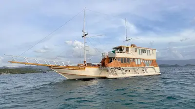 a boat is sitting in the water at Boat Komodo in Seminyak