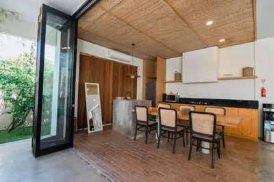 a kitchen and dining room with a table and chairs at Shankara 2 BR Private Pool Villa in Seminyak