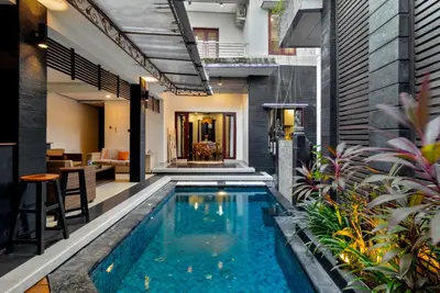 a swimming pool in the middle of a house at Balinese Home with Pool near Padma Beach, Legian in Legian