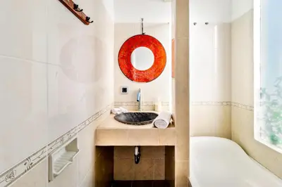 a bathroom with a sink and a tub and a mirror at Balinese Home with Pool near Padma Beach, Legian in Legian