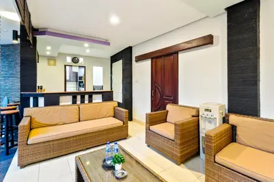 a living room with two couches and a table at Balinese Home with Pool near Padma Beach, Legian in Legian