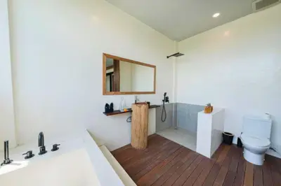 a bathroom with a toilet and a mirror at Quilon 2 BR Private Pool Villa in Seminyak