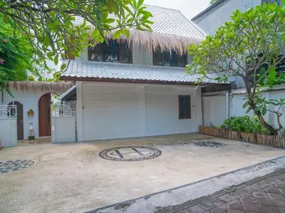 a house with a clock on the ground in front of it at Harbie Villa 1 in Seminyak