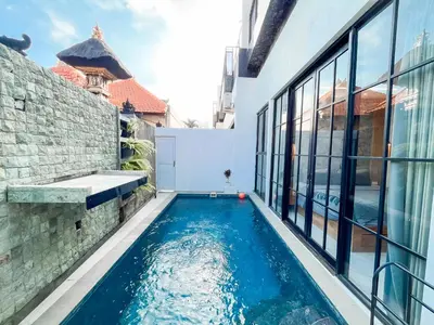 a swimming pool in the backyard of a house at Villa Diah in Seminyak