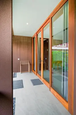 an empty hallway with glass doors and a patio at Bali Radiance 4 bedrooms with private bathrooms - Pool, Beach & Airport in Ngurah Rai International Airport