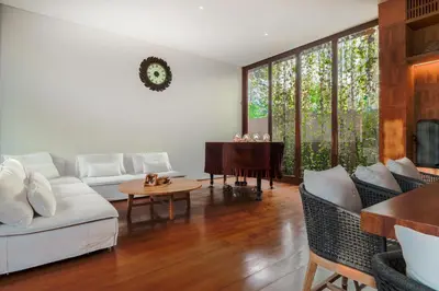 a living room with a white couch and a piano at Bali Radiance 4 bedrooms with private bathrooms - Pool, Beach & Airport in Ngurah Rai International Airport
