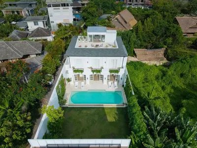 an aerial view of a house with a swimming pool at Colonial House 4BR Villa With Ocean View in Berawa in Canggu