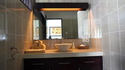 a bathroom with a sink and a mirror at Tahoma Villas Seminyak by ABM in Seminyak