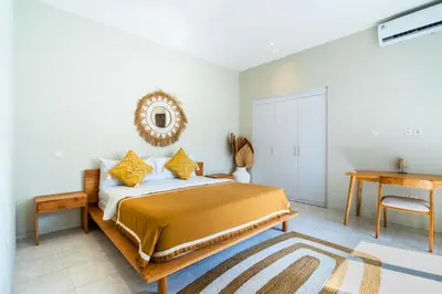a bedroom with a bed and a table and a desk at Ardelle 2 BR Private Pool Villa in Canggu