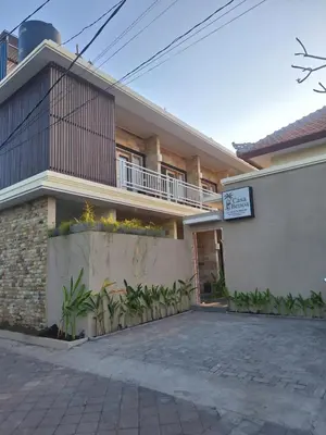 a house with a sign in front of it at Casa Benoa Homestay in Nusa Dua