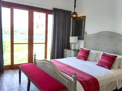 a bedroom with a large bed with red pillows at Tropikal villa 2 bedrooms in seminyak Bali in Seminyak