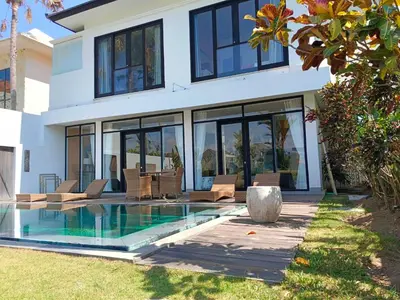 a house with a swimming pool in front of it at Tropikal villa 2 bedrooms in seminyak Bali in Seminyak