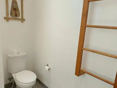 a bathroom with a toilet and a wooden ladder at Tropikal villa 2 bedrooms in seminyak Bali in Seminyak