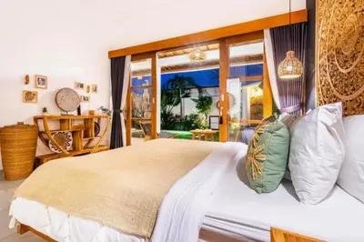 a bedroom with a large bed with a large window at Avery 1 BR Private Pool Villa in Seminyak