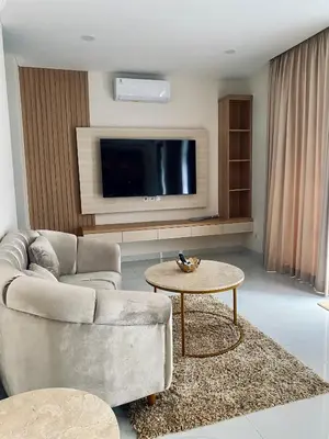 a living room with a couch and a table at Villa Bun Blessi in Pesanggaran
