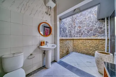 a bathroom with a toilet and a sink at Rumah Bella Private Villa 3 Bedroom 3 Bathroom in Jimbaran