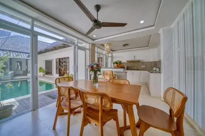 a kitchen and dining room with a wooden table and chairs at Rumah Bella Private Villa 3 Bedroom 3 Bathroom in Jimbaran