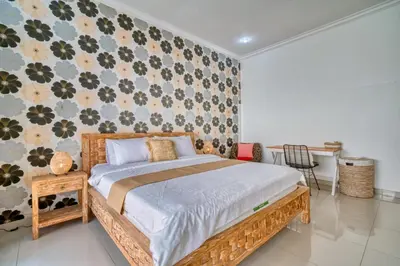 a bedroom with a bed and a floral wall at Rumah Bella Private Villa 3 Bedroom 3 Bathroom in Jimbaran