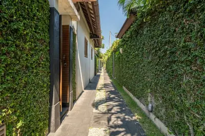 an alley between a building and a hedge at Villa Elegant by Exotiq in Seminyak