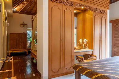 a bedroom with a bed and a kitchen with a sink at Villa Elegant by Exotiq in Seminyak