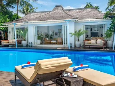 a villa with a swimming pool and a villa at Villa Lulito in Seminyak