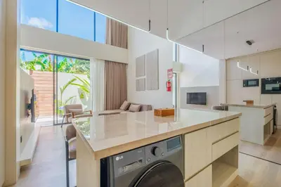 a kitchen with a washer and dryer in a room at Layur Villa in Canggu